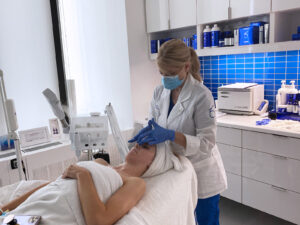 Jennifer performing skincare treatment