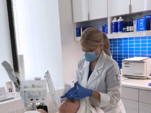 Jennifer performing skincare treatment