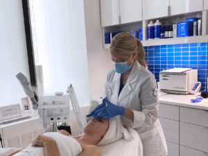 Jennifer performing skincare treatment